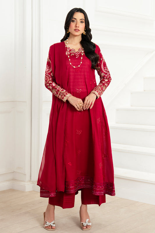 Woman wearing a red traditional outfit with white embroidery against a white background