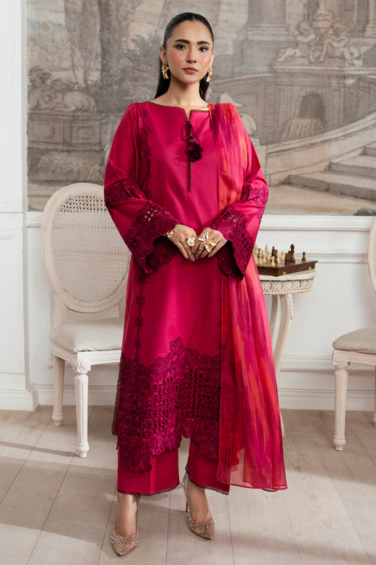 Woman in a red traditional outfit standing in an elegant room with classical decor.