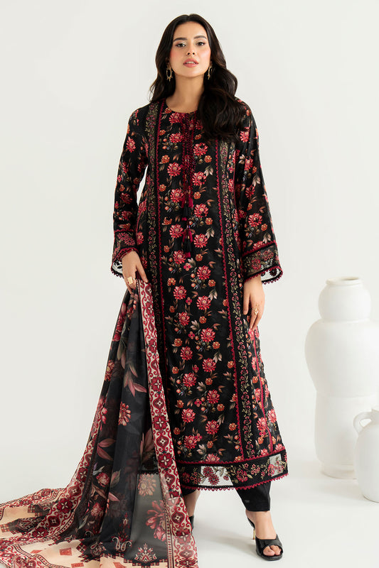 Woman wearing a black floral dress with a matching dupatta on a white background