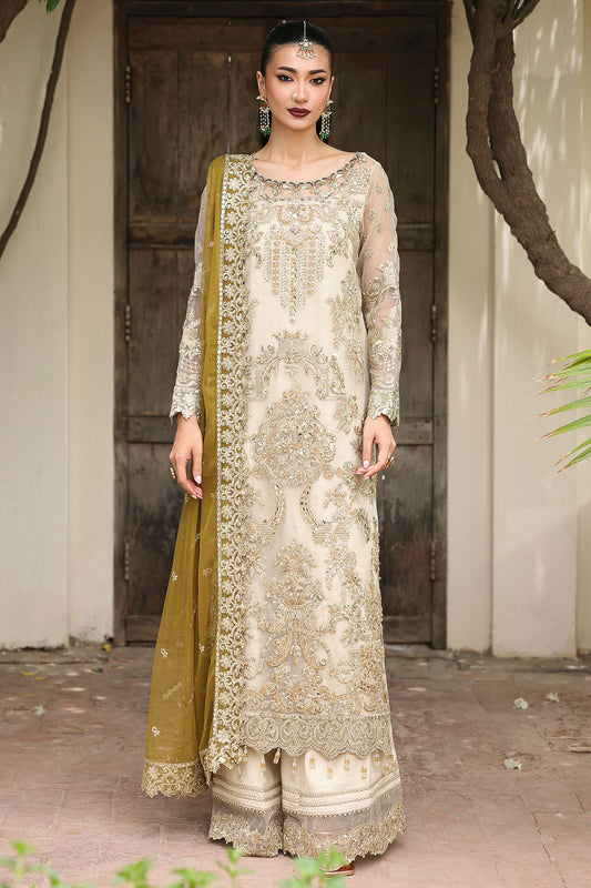 Woman wearing a traditional outfit with a green dupatta in an outdoor setting.
