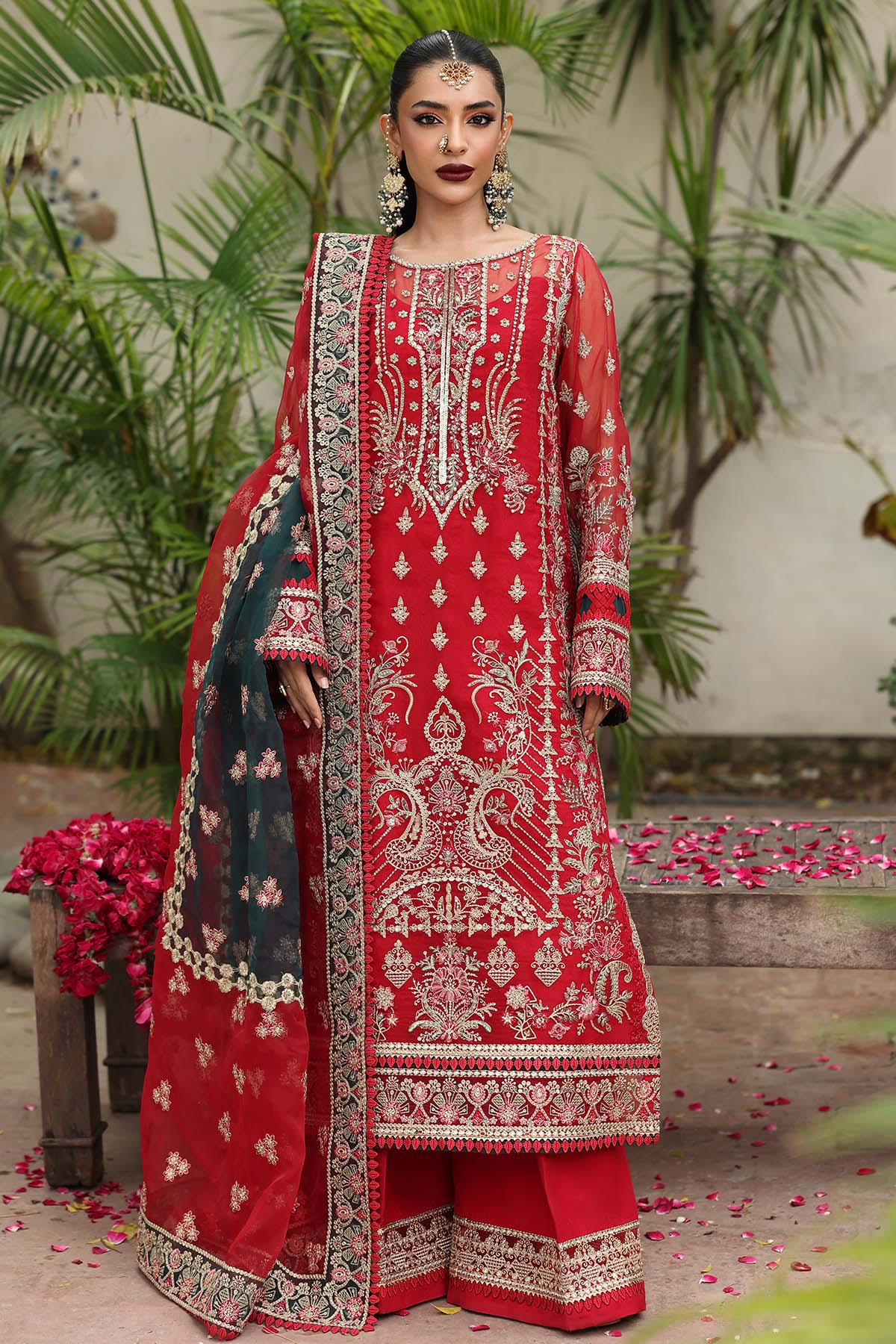 Woman wearing a red embroidered traditional outfit with a floral background