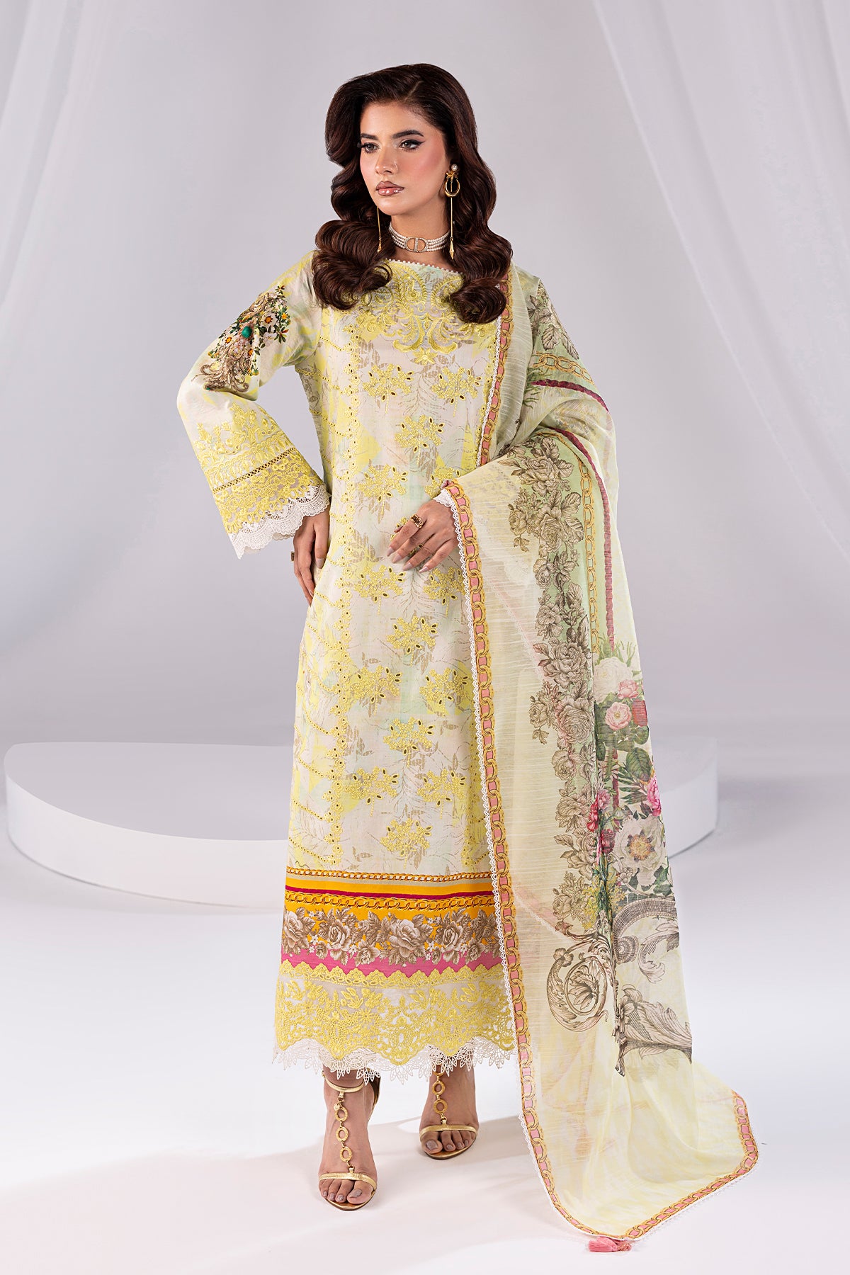 Woman wearing a traditional outfit with floral patterns on a white background